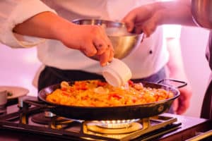 Koch bereitet Paella vor